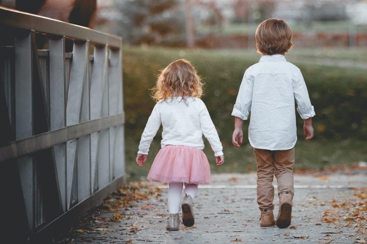 How Can Childhood Hearing Loss Affect Vocabulary? Two children walking on a bridge