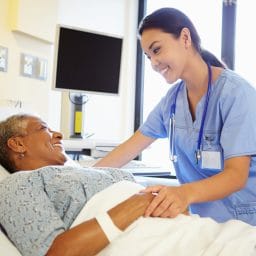 Nurse talking to a patient in the hospital.