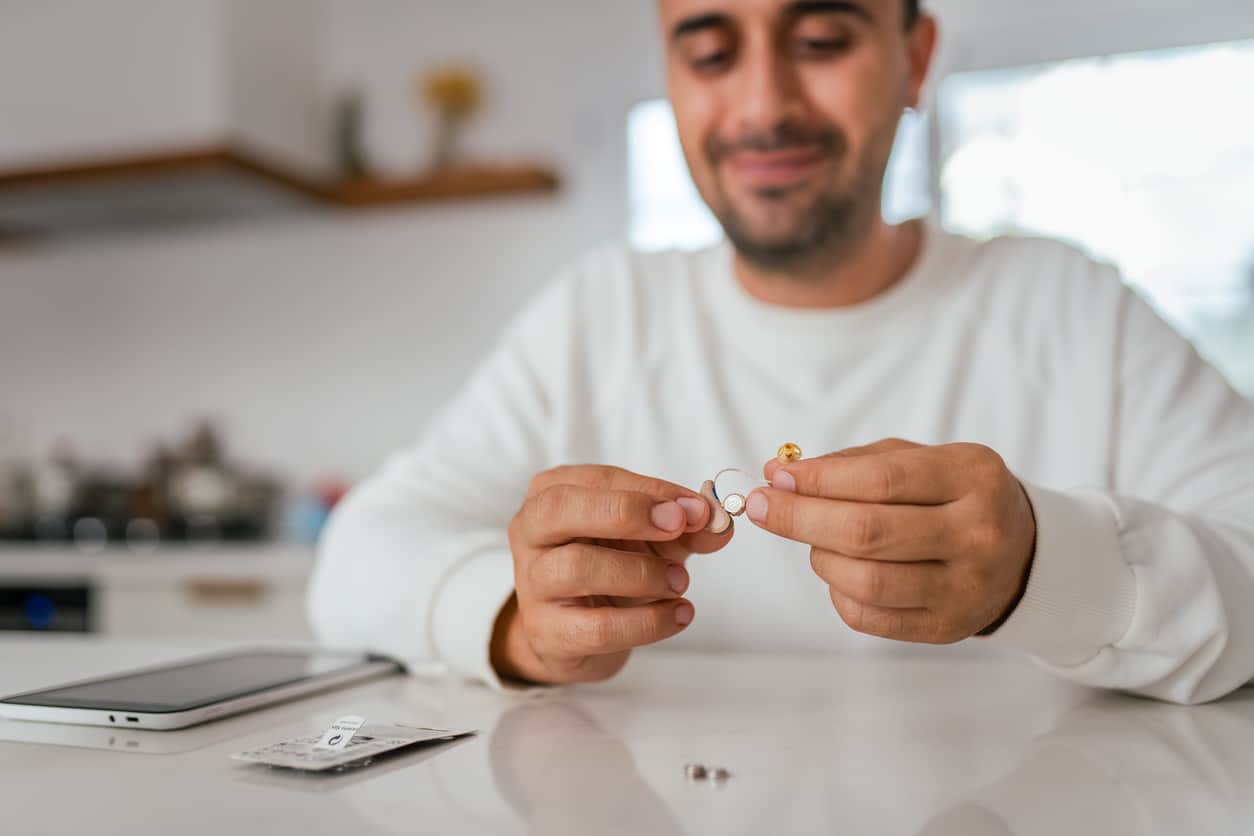 Man taking a look at his hearing aids