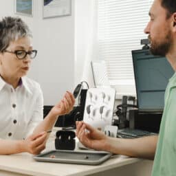 Audiologist and her patient discuss hearing aid microphone options.