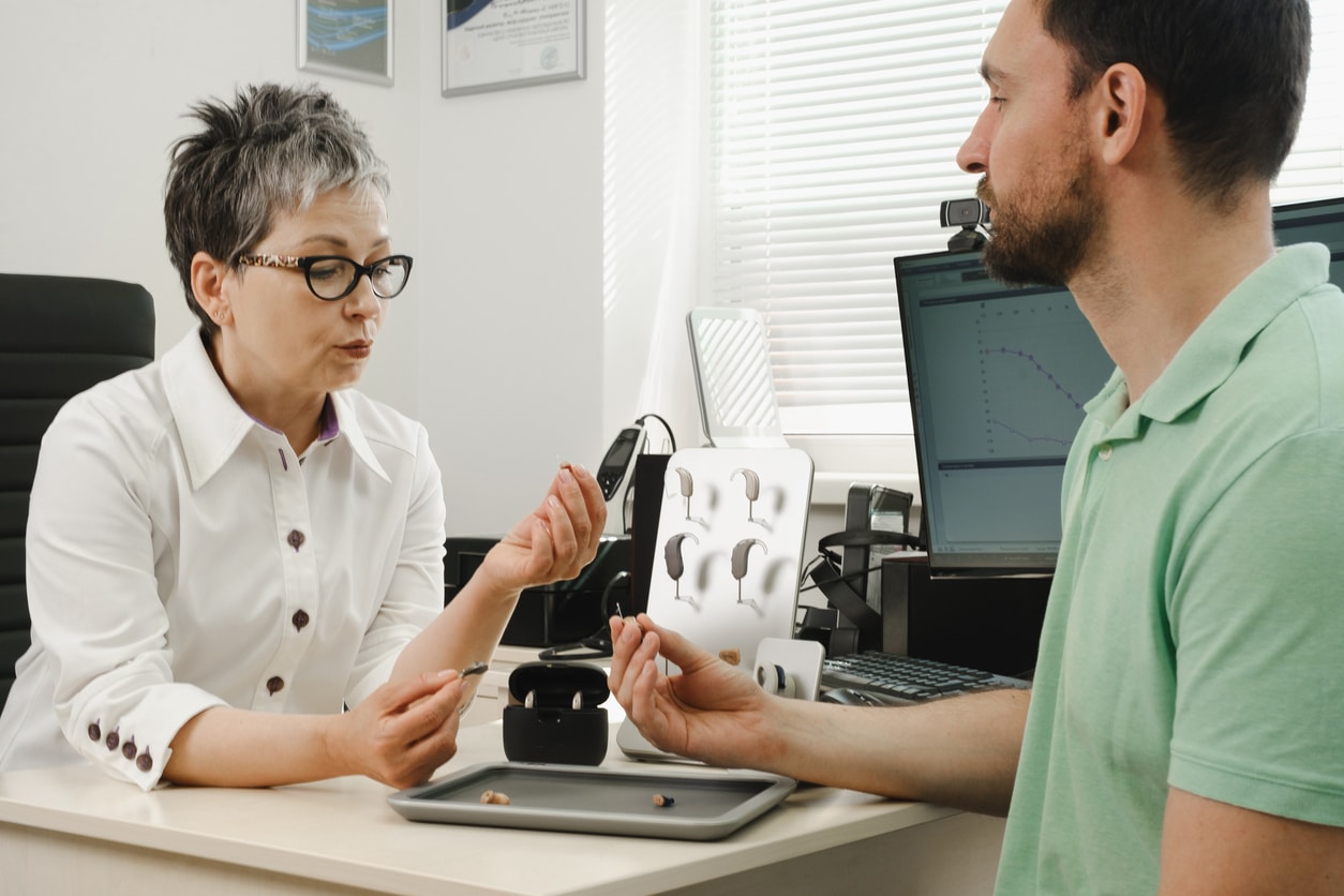 Audiologist and her patient discuss hearing aid microphone options.